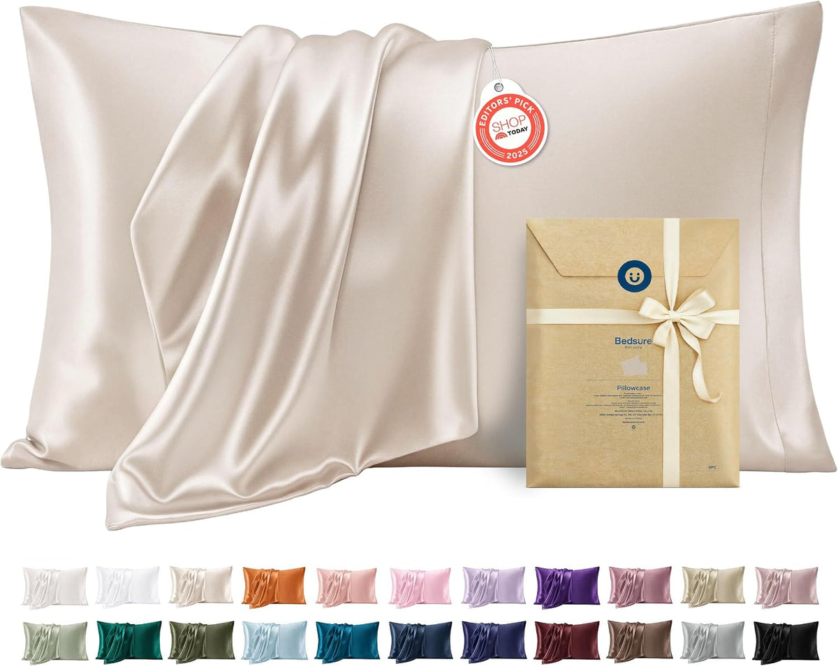 grey satin pillowcase pair neatly folded on a white surface
